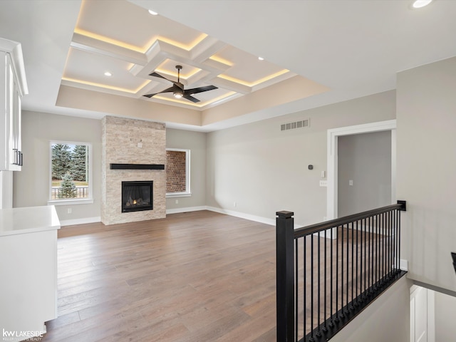 unfurnished living room with visible vents, recessed lighting, coffered ceiling, a ceiling fan, and wood finished floors