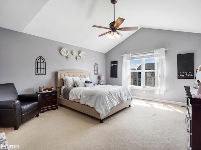 bedroom featuring lofted ceiling, a ceiling fan, baseboards, and light colored carpet