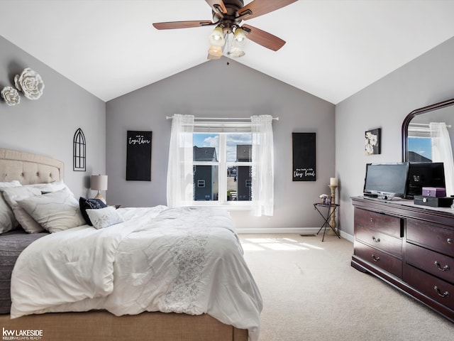 bedroom with light colored carpet, lofted ceiling, a ceiling fan, and baseboards