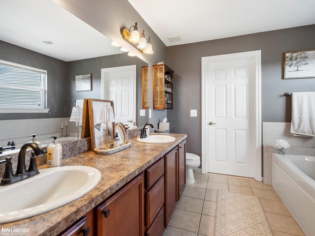 bathroom with a bath, visible vents, tile patterned floors, and a sink