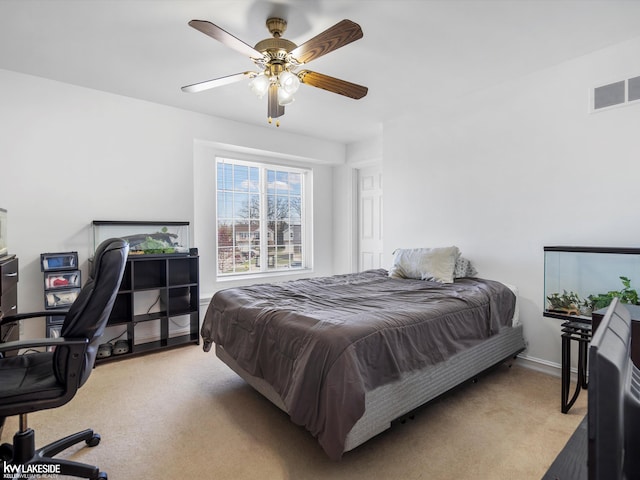 bedroom featuring visible vents, a ceiling fan, baseboards, and light carpet