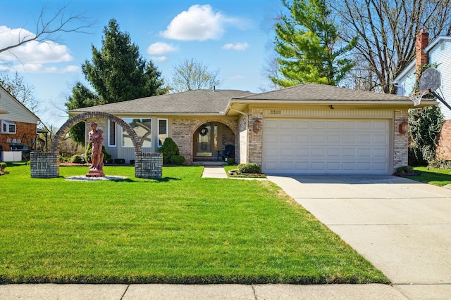 ranch-style home featuring a garage, driveway, a front yard, and brick siding
