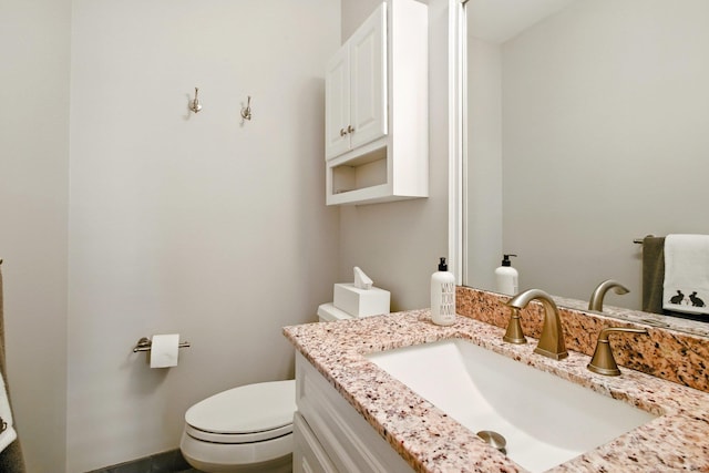 bathroom with toilet and vanity