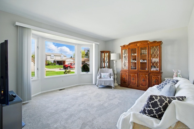 sitting room featuring baseboards, carpet flooring, and visible vents