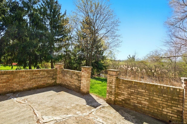 view of gate featuring a patio area and fence
