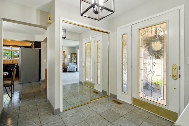entrance foyer featuring a notable chandelier and visible vents