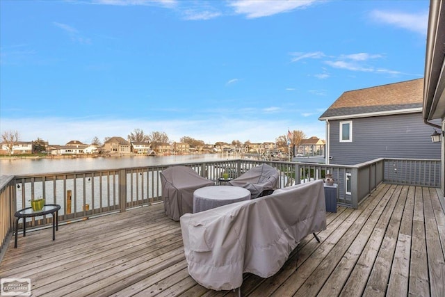 wooden terrace featuring a residential view and a water view