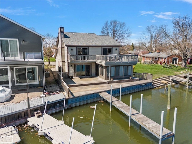 dock area with a water view and a balcony