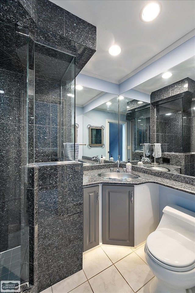 bathroom featuring tile patterned floors, a tile shower, toilet, recessed lighting, and vanity