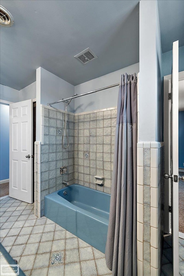 full bathroom with visible vents, tile patterned flooring, and shower / tub combo with curtain