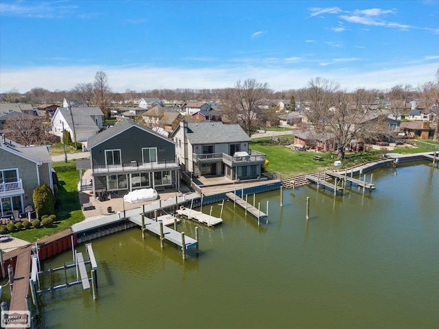 drone / aerial view with a water view and a residential view