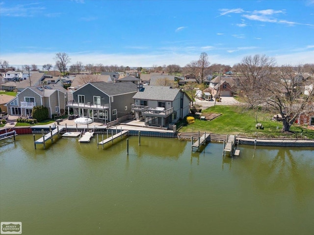 bird's eye view featuring a residential view and a water view