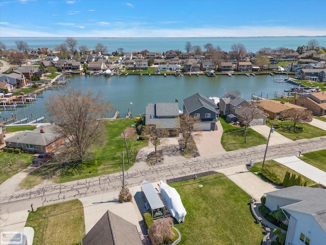 drone / aerial view with a water view and a residential view