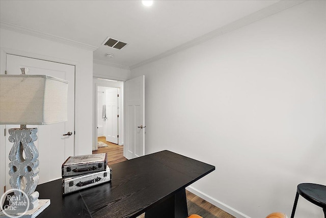 office featuring crown molding, baseboards, visible vents, and wood finished floors
