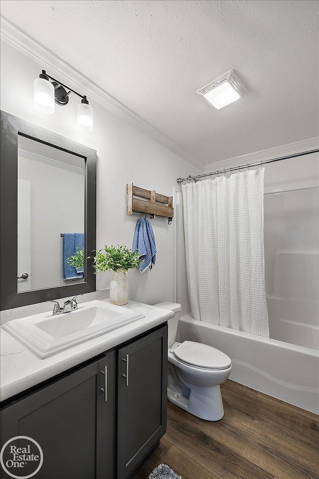 bathroom with vanity, a textured ceiling, wood finished floors, shower / tub combo, and ornamental molding