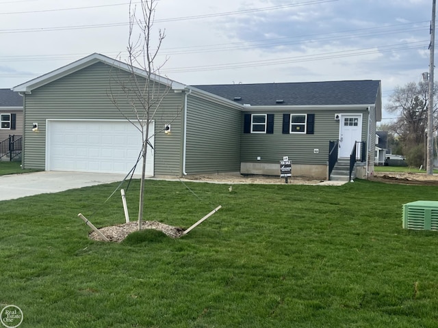 single story home featuring an attached garage, entry steps, a front yard, and concrete driveway