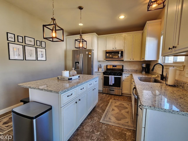 kitchen with stainless steel appliances, a sink, a kitchen island, light stone countertops, and decorative backsplash