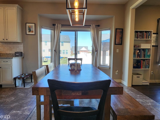 dining space with plenty of natural light and baseboards