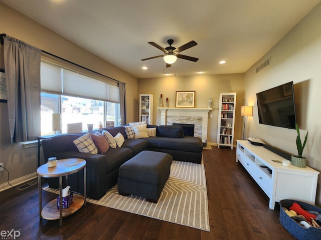 living room featuring hardwood / wood-style flooring, a ceiling fan, and visible vents