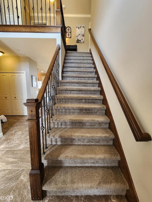 stairs featuring baseboards and crown molding
