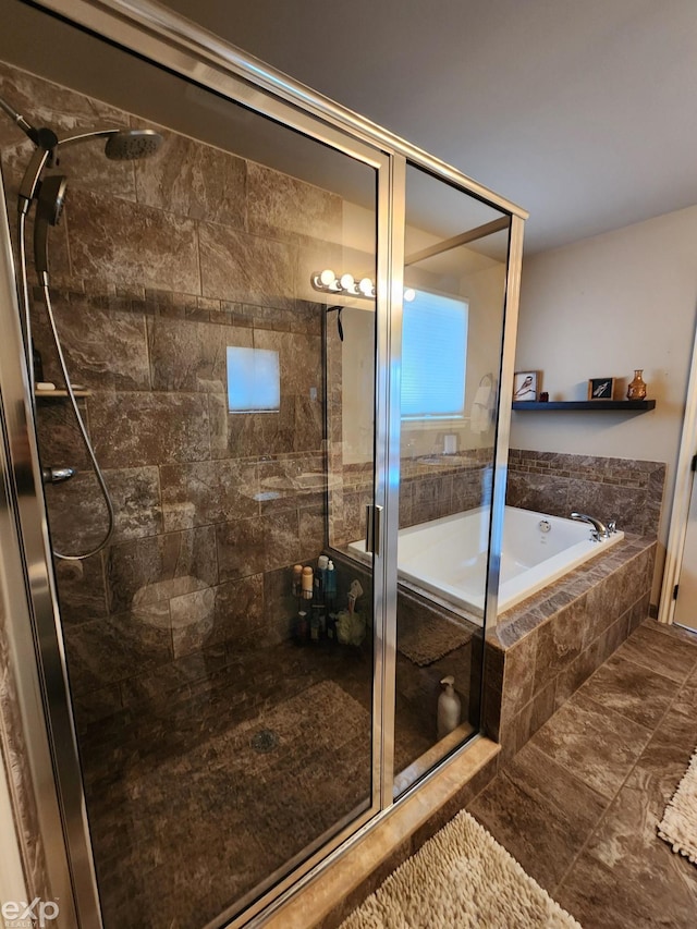 bathroom featuring a garden tub and a stall shower