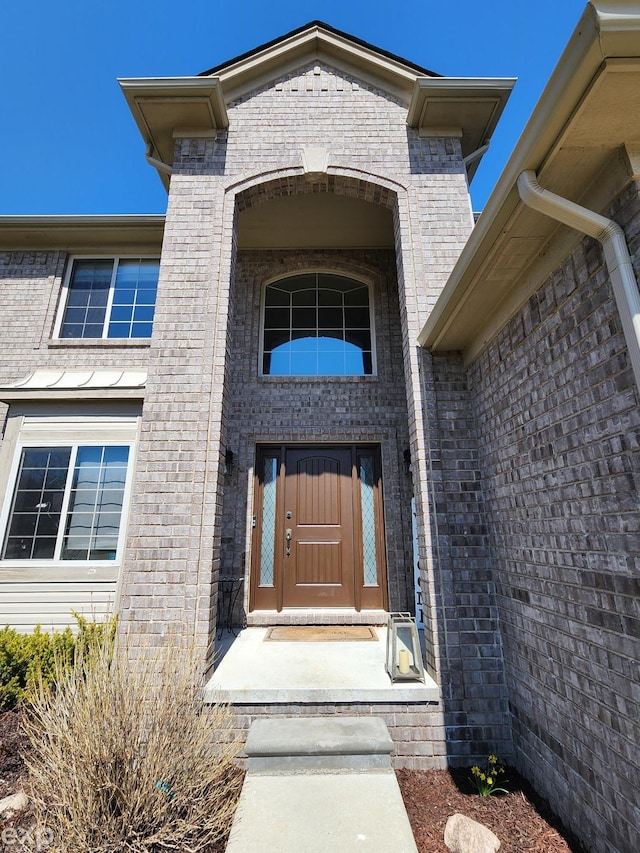 property entrance with brick siding