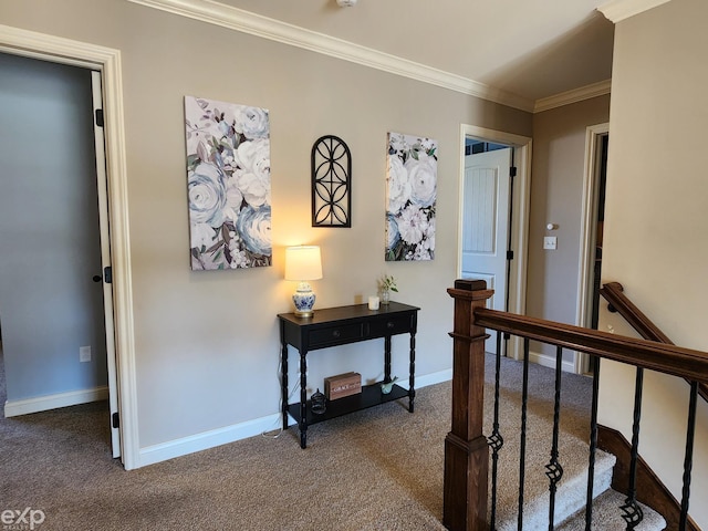 corridor featuring baseboards, carpet flooring, an upstairs landing, and crown molding