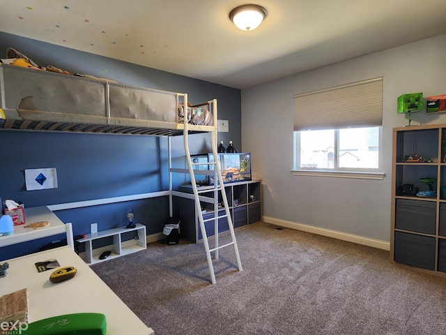 bedroom with baseboards and carpet