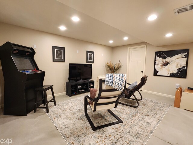 interior space with baseboards, concrete flooring, visible vents, and recessed lighting