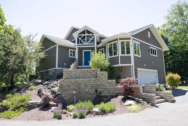 craftsman-style house featuring driveway and a garage
