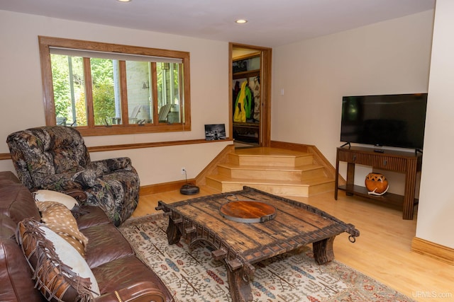 living area with recessed lighting, wood finished floors, and baseboards