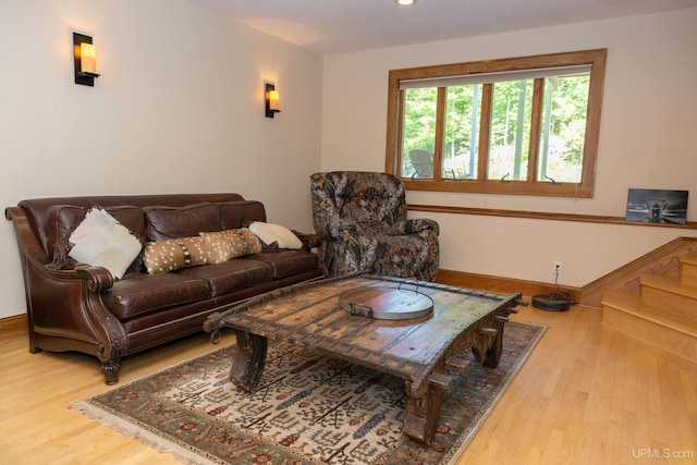 living area with baseboards, wood finished floors, and recessed lighting
