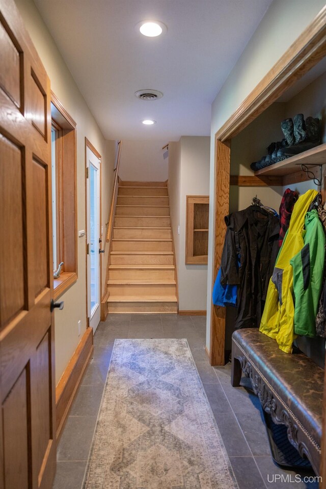 mudroom with recessed lighting, visible vents, baseboards, and dark tile patterned flooring