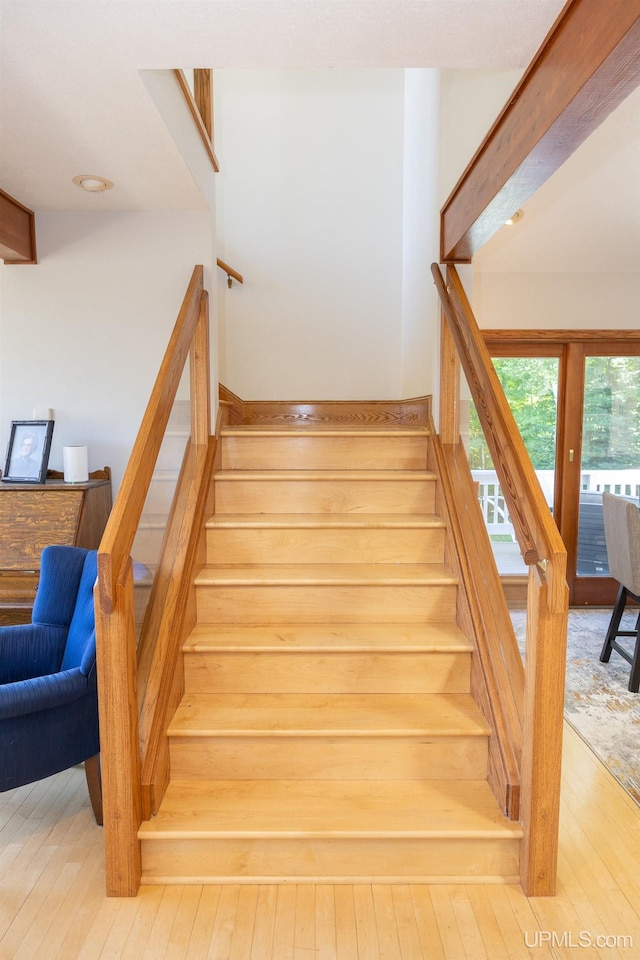 staircase with hardwood / wood-style flooring
