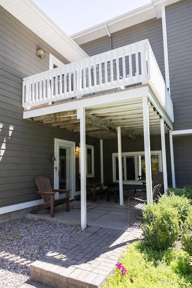 rear view of house with a patio and a deck