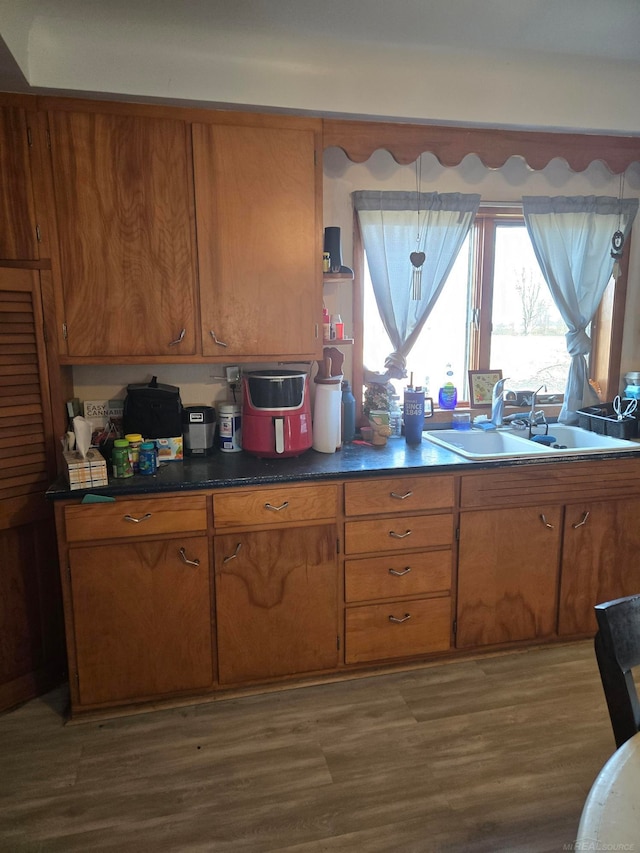2255 E Sanilac Rd, Carsonville, MI 48419 - kitchen with brown cabinetry, dark wood-type flooring, dark countertops, and open shelves