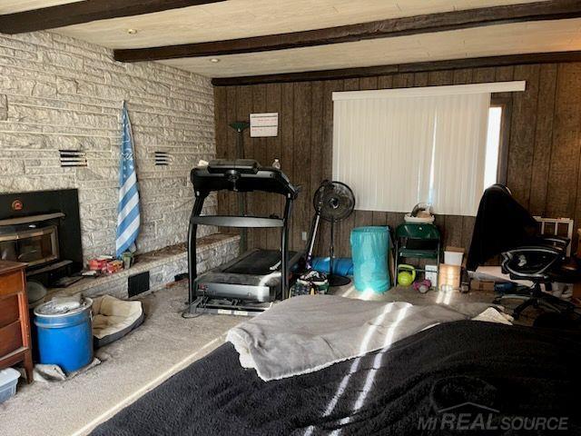 2255 E Sanilac Rd, Carsonville, MI 48419 - carpeted living area with beamed ceiling and wooden walls