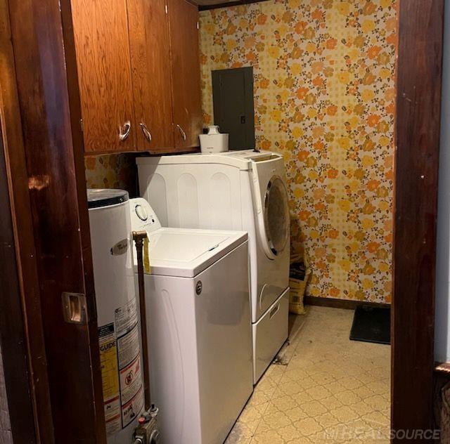 2255 E Sanilac Rd, Carsonville, MI 48419 - laundry room with wallpapered walls, washing machine and dryer, electric panel, cabinet space, and water heater
