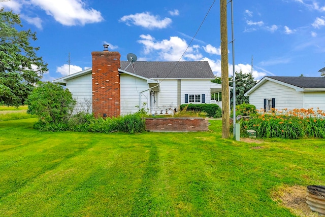 2255 E Sanilac Rd, Carsonville, MI 48419 - rear view of house with a yard and a chimney