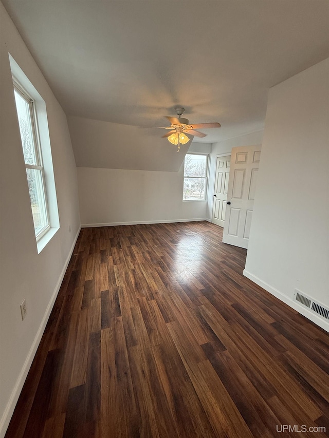 231 E Chocolay St, Munising, MI 49862 - additional living space with visible vents, a ceiling fan, baseboards, and dark wood-style flooring