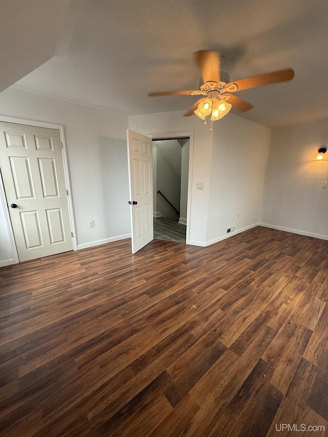 231 E Chocolay St, Munising, MI 49862 - spare room featuring baseboards, visible vents, a ceiling fan, and dark wood-style floors