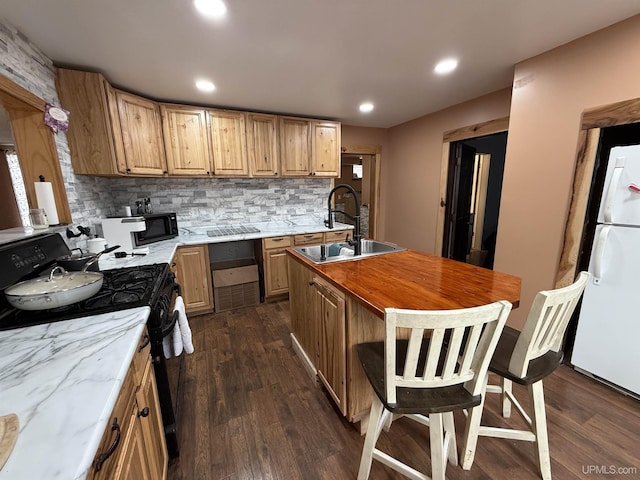 231 E Chocolay St, Munising, MI 49862 - kitchen with dark wood finished floors, black appliances, tasteful backsplash, and a sink
