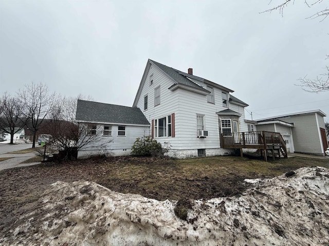 231 E Chocolay St, Munising, MI 49862 - view of side of property with a chimney, a wooden deck, roof with shingles, and cooling unit