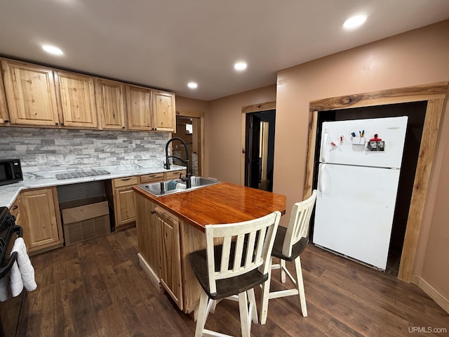 231 E Chocolay St, Munising, MI 49862 - kitchen featuring a sink, black microwave, dark wood finished floors, stove, and freestanding refrigerator