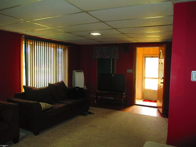 living room with wood finished floors and a drop ceiling