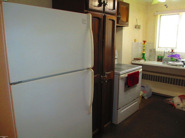 kitchen featuring light countertops and white appliances