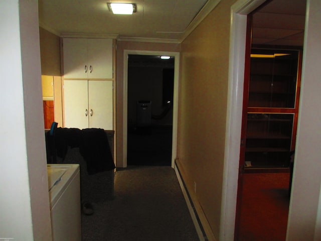 hallway featuring carpet flooring, washing machine and dryer, baseboards, baseboard heating, and ornamental molding