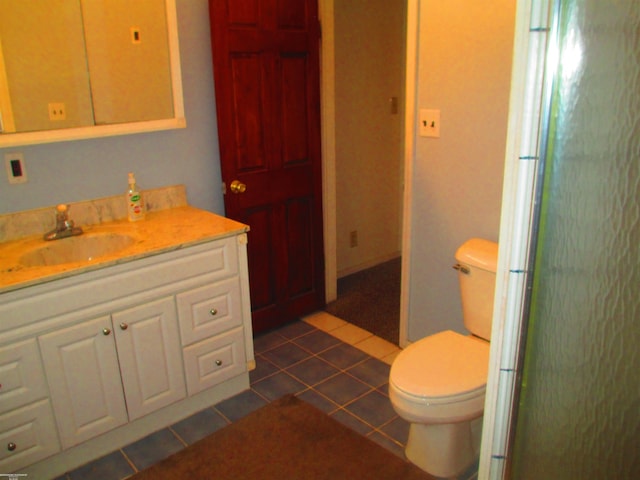 full bathroom featuring toilet, vanity, and tile patterned floors