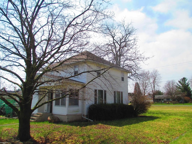 view of side of home featuring a yard