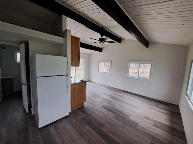 kitchen featuring dark wood finished floors, freestanding refrigerator, baseboards, lofted ceiling with beams, and ceiling fan